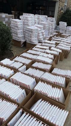 many boxes filled with files sitting on the ground