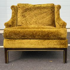 a yellow chair sitting in front of a white wall