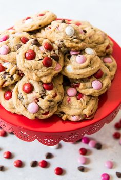 a red plate filled with chocolate chip cookies