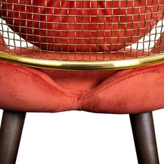 a red chair with a gold frame on it's back and legs, sitting in front of a white background