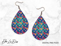 a pair of colorful earrings on top of a white marble surface with the words, digital png files