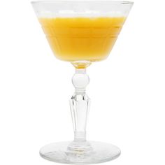 a glass filled with orange juice on top of a white table