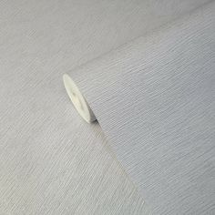 a roll of white fabric sitting on top of a table