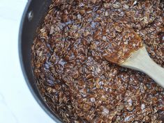 a wooden spoon in a pot filled with food