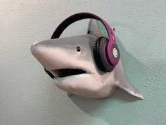 a shark headphone mounted to the side of a wall