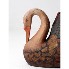 a close up of a wooden duck on a white background