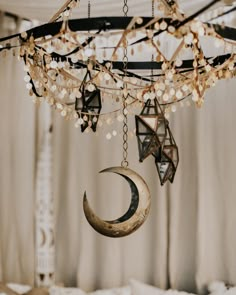 a crescent and star hanging from a chandelier in a room with drapes