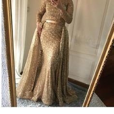 When you're looking for a beautiful dress that is both elegant and stylish, you'll find no better option than the Muslim Gold Mermaid dress. This exquisite evening gown is made of luxurious, shimmering satin and features a long train with a delicate train. It's perfect for proms, weddings, or other formal occasions. Muslim Gold Mermaid dress is an amazing evening dress for Muslim woman, it is sweeping and silky, sparkling and long, when you wear it for to a party, the whole people will turn to look at you. This dress is suitable for any occasion such as party, prom night, show, evening out. The dress made of high quality material ,beautiful design and fashionable style. Dazzle in this gold and silver mermaid evening dress for the most captivating look. This long evening gown is perfect for Gold Mermaid Dress With Sweep Train, Gold Mermaid Dress With Sweep Train Floor-length, Elegant Shimmer Evening Dress, Long Sleeve Shimmer Dresses For Prom, Elegant Gold Shimmer Evening Dress, Gold Floor-length Mermaid Dress With Sweep Train, Gold Mermaid Dress For Wedding And Prom Season, Glamorous Gold Sequin Evening Dress, Gold Long Sleeve Gala Evening Dress