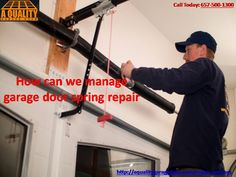 a man working on an overhead garage door repair