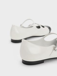 This iteration of the ever-popular Mary Janes will certainly make you do a double take. Subtle details come together to create a striking design, like the double buckled straps and T-bar design. For a striking yet classic silhouette, the clean white finish is topped off with contrasting black toe caps. Complete with rounded toes and low block heels for all-day comfort, these shoes are effortlessly sleek and stylish. Low Block Heels, Charles Keith, Double Take, Classic Silhouette, Sneakers Athletic, Bar Design, The Double, Come Together, Mary Janes