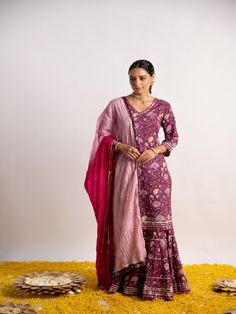 Purple floral print Straight kurta detailed with gotta lines on hem and sleeves, has a three-quarter sleeves, V neck. Purple printed sharara with heavy gotta lines on hem, this kurta sharara comes with pink ombre dupatta highlighted with border. Fabric: Cotton Color: Purple and Pink Note: Wash Care Instruction - Dry Clean Only The product will be shipped within 15-20 days of order placed Size Chart: Kurta Size XS S M L XL XXL XXXL Bust 36 38 40 42 44 45 Waist 32 34 36 38 40 42 Hip 38 40 42 44 46 Fitted Purple Sharara With Floral Embroidery, Semi-stitched Purple Sharara With Resham Embroidery, Embroidered Purple Sharara, Semi-stitched Embellished Purple Sharara, Semi-stitched Embroidered Purple Sharara, Cotton Sharara, Ombre Dupatta, Printed Sharara, Kurta Sharara