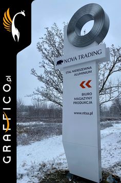 a white sign sitting on the side of a snow covered field