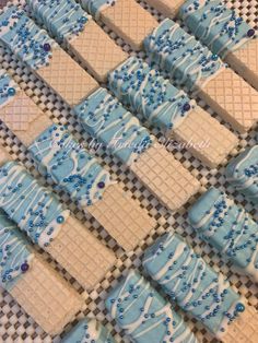 blue and white decorated cookies sitting on top of a checkered table