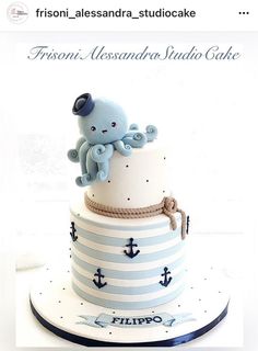 a three tiered cake decorated with an octopus and sailor's knot on top