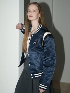 This casual varsity jacket features classic and sporty details like stripe trim, contrasting button and embroidered logo applique. It's finished with lightweight 3 oz filling for adding warmth.- Snap button fastenings- Initial A logo patch at chest - Embroidered logo patch at back- Two front welt pockets- Stripe ribbed trim at neck, cuffs and hem- 3oz filling- Semi-oversized fit - Unisex wear Varsity Style Outerwear With Logo Patch For Winter, Varsity Style Outerwear With Logo Patch For College, Classic Navy Varsity Jacket For College, Collegiate Varsity Jacket With Logo Patch For Winter, Sporty Varsity Jacket With Logo Patch For College, College Varsity Jacket With Striped Cuffs And Baseball Collar, Varsity Style Track Jacket With Baseball Collar For College, Sporty Outerwear With Contrast Stripes For Streetwear, Varsity Jacket With Ribbed Cuffs For College