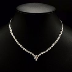 She'll never tire of wearing this classic and sophisticated diamond tennis necklace. Stunning in 18K solid white gold, this breathtaking line of shimmering round diamonds. So elegant, this 18.0-inch diamond necklace will take her breath away. Radiant with 3.08 cts. t.w. of diamonds and buffed to a brilliant luster, this glamorous keepsake secures with a box clasp. The setting design make the diamonds look much bigger than they are. When worn, the diamonds look like 1/5 carat each. Diamonds Detai Luxury Diamond White Diamond Necklace With Polished Finish, Luxury White Gold Diamond Necklace With Brilliant Cut, Luxury White Gold Diamond Necklace With Round Stone, Luxury Diamond White Round Cut Bridal Necklace, Luxury Diamond White Necklace For Celebration, Luxury White Brilliant Cut Diamond Necklace, Luxury White Gold Diamond Cut Necklace, Modern Luxury Diamond Necklace For Anniversary, Luxury White Gold Round Cut Bridal Necklace