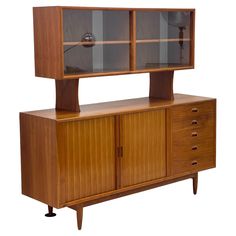 a wooden cabinet with glass doors and drawers on it's sides, against a white background