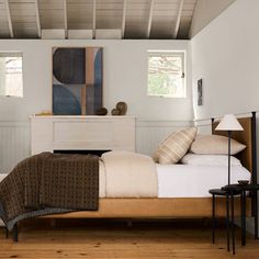 a bed sitting in a bedroom on top of a hard wood floor