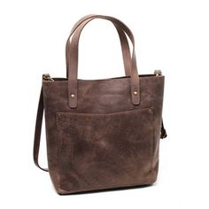 Take your accessories with comfort in our Dark Brown Leather Tote Bag. This bag is best for daily use, as it is easy to carry. You can wear its soft leather straps over your shoulder, keeping all your necessary items with you. This leather tote bag has a sleek, elegant design. It makes any regular outfit unique. Made of Cowhide leather, this bag lasts longer than ordinary tote bags and offers a touch of sophistication. This fascinating design and a good space make it the best bag for daily use. Leather Shoulder Bag With Waxed Finish For On-the-go, On-the-go Leather Strap Satchel, Double Handle Shoulder Bag With Leather Strap For Travel, On-the-go Waxed Leather Shoulder Bag, Travel Shoulder Bag With Double Handle And Leather Strap, Everyday Leather Strap Satchel Bucket Bag, Leather Strap Bucket Bag Tote For Travel, Leather Strap Crossbody Satchel For Everyday Use, Casual Everyday Shoulder Bag With Leather Strap