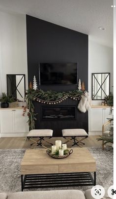 the living room is decorated for christmas with candles and greenery on the mantel