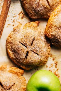 apple pies and cinnamon sticks on a baking sheet