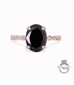 an oval black diamond ring with rose gold accents