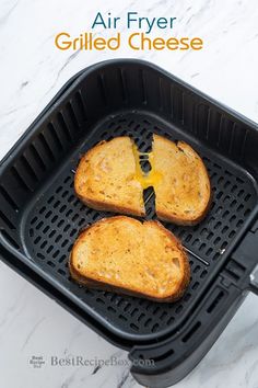 two pieces of grilled cheese sitting on top of a black pan with the words air fryer grilled cheese