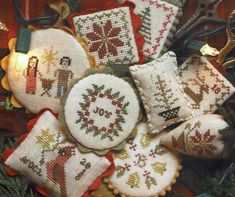 cross stitch ornaments are arranged in a basket