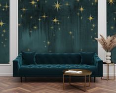 a living room scene with focus on the couch and stars painted on the wall behind it