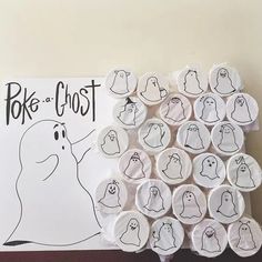 a bunch of buttons that have been placed in front of a sign with ghost faces on them