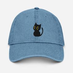 a blue hat with a black cat embroidered on it