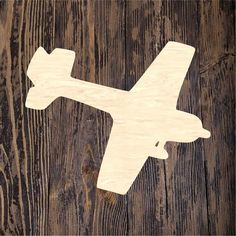 a wooden cutout of an airplane on a wood background