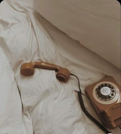 an old phone is laying on the bed