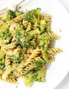 a white plate topped with pasta and broccoli