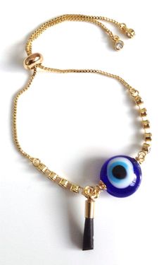 "Evil eye Jewelry Great adjustable rhinestone box chain of laminated gold with a 1.2cm lampwork evil eye and a genuine azabache jet hand shape. This piece brings good luck, good vibes and serves as protection against evil eye and envy. This eye-catching bracelet can be adjusted to any length if needed, It is secure and comfortable to put in-out by yourself. It's a great look for daytime, clean line, fashion and urban look, and could be a perfect birthday gift for someone exposed to negative envi Adjustable Gold Evil Eye Bracelet With Charms, Adjustable Gold Charm Bracelet With Evil Eye, Gold Spiritual Evil Eye Bracelet With Adjustable Chain, Gold Evil Eye Bracelet With Charms For Gift, Gold Evil Eye Bracelet With Charms As Gift, Gold Metal Evil Eye Bracelet As Gift, Gold Metal Evil Eye Bracelet For Gift, Gold Spiritual Evil Eye Bracelet Gift, Gold Evil Eye Bracelet - Gift