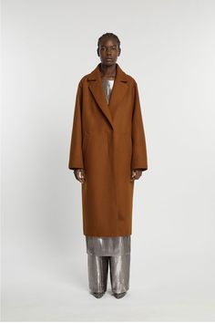 This coat is made from a wool and cashmere fabric woven in Italy near lake Lugano. The structured and slightly oversized cut was designed with precision. Details include raglan pockets, a concealed button packet with corozo buttons and a back vent. The inside of the coat is lined in viscose and the concealed part of the collar is made of mottled wool felt. WHY WE LOVE IT INDRESS was founded in Paris in 2001 by Dutch designer Wies Schulte with the desire to combine elegance, timeless shapes and v Lake Lugano, Derek Rose, Library Art, Wooden Games, Jerome Dreyfuss, Cashmere Fabric, Bath Gift, Knit Shoes, Man Child