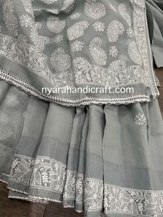 Gray chikankari saree has a subtle border and paisley motifs on the palla, finished with crocheted lace. *Petticoat included! *Hand embroidered *Includes an embroidered blouse piece *Fall attached Cotton Sharara With Embroidered Border, Wedding Cotton Sharara With Embroidered Border, Fitted Cotton Sharara With Intricate Embroidery, Unstitched Cotton Saree With Chikankari Embroidery, Semi-stitched Cotton Dupatta With Lace Work, Cotton Sharara With Chikankari Embroidery, Festive Cotton Dupatta With Lace Work, Fitted Cotton Dupatta With Lace Work, Bollywood Style Cotton Sharara With Intricate Embroidery