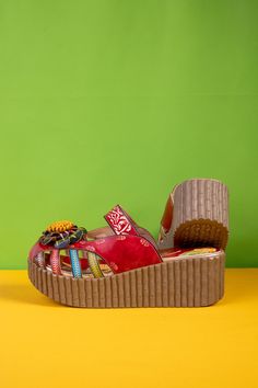 a pair of colorful shoes sitting on top of a yellow floor next to a green wall