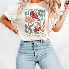 Consider How The Wildflowers Grow Shirt, Luke 12:27 Floral Faith Tee, Boho Christian Shirt, Bible Verse Shirt, Trendy Christian T-Shirts Embrace your faith with our beautiful "Consider How The Wildflowers Grow" shirt, inspired by the uplifting message of Luke 12:27. This trendy Christian T-shirt perfectly combines style and spirituality, featuring a stunning floral design that embodies the beauty of God's creations. Made for those who appreciate both fashion and their faith, this boho Christian Luke 12 27, Boho Christian, Luke 12, Freedom Shirts, Faith Tees, Bible Verse Shirt, Christian T Shirts, Christian Shirt, Christian Shirts