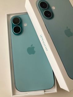 two new iphones are in the box, one is blue and the other is green