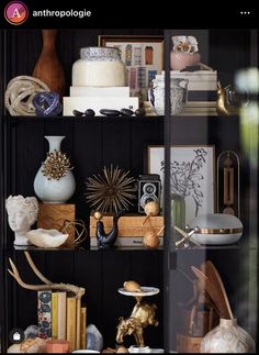 a shelf filled with lots of different types of vases and other decorative items on top of it