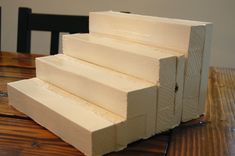 a stack of white blocks sitting on top of a wooden table