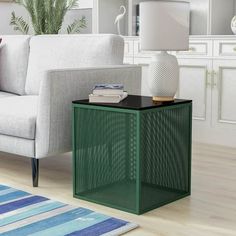 a living room with a white couch and green side table