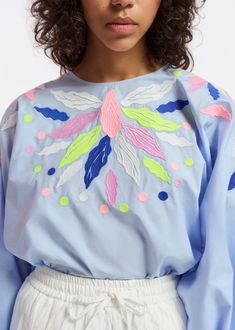 Top is cut from a crisp cotton-poplin decorated with colorful embroideries. the style is detailed with voluminous sleeves that fall to elasticated cuffs and a round neckline.    - 100% cotton  - lightweight non-stretchy fabric  - intended for an oversized fit  - hidden zip fastening at the back  - voluminous sleeves with elasticated cuffs  - embroidery details  - light blue/dark blue/lime green    fabric    100% cotton  embroidery: 100% polyester    washing instructions    machine washable Colourful Embroidery, Wide Leg Jeans Cropped, Embroidery Top, Leopard Print Blouse, Tablet Sleeve, Cotton Embroidery, Fall Coat, Engineered Garments, Embroidery Details