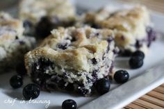 blueberry crumb bars sitting on top of a white plate