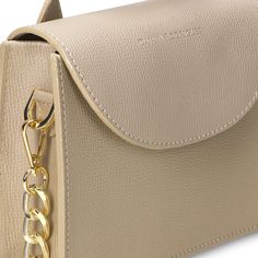 Enhance your accessory collection with this elegant beige handbag, adorned with sleek silver hardware. Made from premium leather, it features a practical interior space for essentials and includes a hand holder and a chain. Ideal for the modern woman, this handbag reflects strength and sophistication. Beige Handbag, Silk Scarf Hair, Beige Handbags, Backpack Travel Bag, Small Leather Goods, Scarf Hairstyles, Long Wallet, Silver Hardware, High Quality Leather