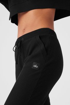 Meet the sweats you’ve seen all over your feed. They’re done in a plush, incredibly soft, wide-ribbed fabric that feels as good as it looks. The jogger-style silhouette is luxuriously cozy with a high-rise waistband and ankle cuffs. Make it a matching set with the Muse Hoodie. Black Ribbed Cotton Bottoms, Sporty Ribbed Activewear For Loungewear, Alo Yoga Activewear With Ribbed Waistband For Loungewear, Sporty Ribbed Bottoms For Fall, Cozy Ribbed Sweatpants For Lounging, Athleisure Ribbed Lounging Bottoms, Sporty Ribbed Lounging Bottoms, Comfortable Relaxed Fit Ribbed Sweatpants, Ribbed Athleisure Bottoms For Lounging