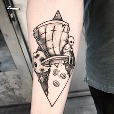 a black and white photo of a person with a tattoo on his arm, holding a pizza slice