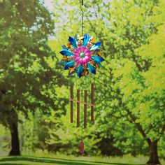 a colorful wind chime hanging from a tree