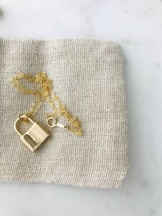 "Padlock Necklace * 14k gold filled Beautiful padlock necklace! The pendant is made of thick 18k gold filled. Great quality and fun to layer with other necklaces. d e t a i l s -- 14k gold filled chain -- 14k gold filled spring clasp closure -- 18k gold filled padlock measure 20MM * model is wearing 18\" Necklace comes in a kraft jewelry box with a bow on top h o w * t o * o r d e r 1. please select options from the dropdown menu 2. add to cart and proceed to checkout 3. then place your order g 14k Gold Necklace With Gold Clasp For Gift, 14k Gold Jewelry With Gold Clasp For Gift, Gold Necklace For Everyday Use, Everyday Gold Lock Jewelry, Everyday Gold Jewelry With Lock Detail, Minimalist Lock Jewelry For Gifts, Minimalist Lock Jewelry As Gift, Minimalist Jewelry With Lock As A Gift, Minimalist Lock Jewelry As A Gift